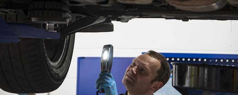 Technician inspecting vehicle