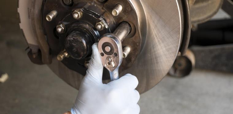 mechanic changing a disc rotor in a garage