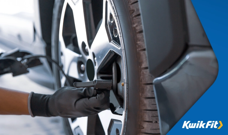 Tyre pressure being checked on a vehicle.