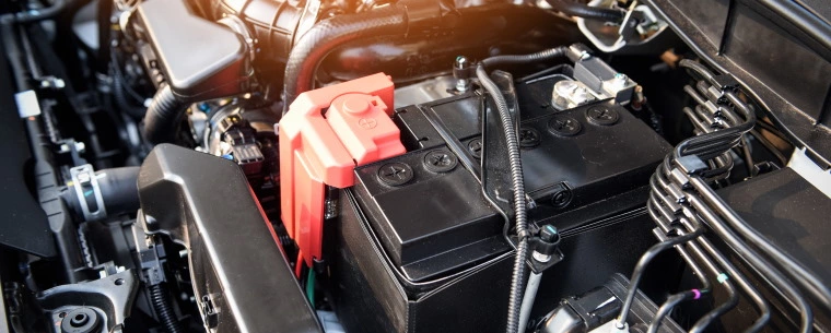 Car battery underneath a bonnet