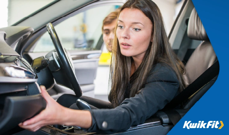 Person opening the glovebox of a car.