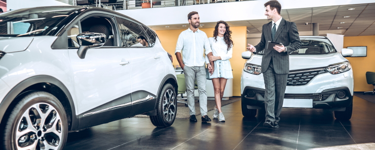 Couples browsing cars