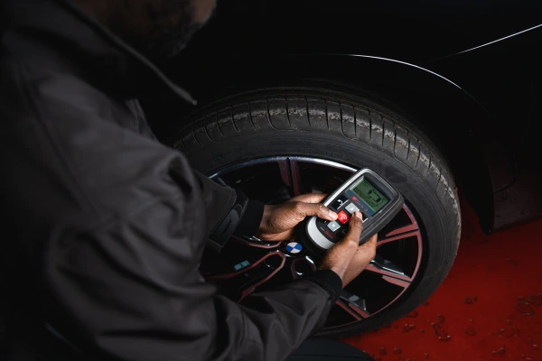 Kwik Fit technician checks tyre pressure