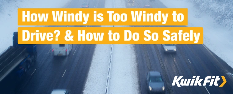 Cars driving on a British motorway in heavy snow and wind.