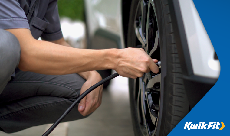 Person putting air into tyres.