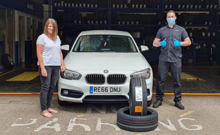 Customer receiving free tyres at Kwik Fit