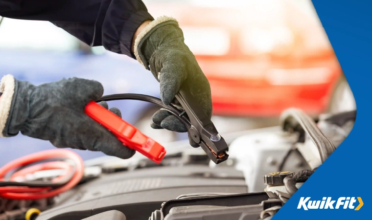 Attaching positive and negative jump cables to a car battery.