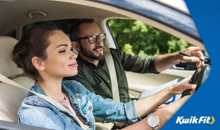 A learner driver is being given directions by their instructor.