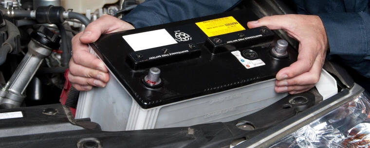 Man changing a battery and removing the old one