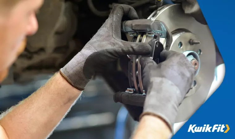 A mechanic changing a brake disc.