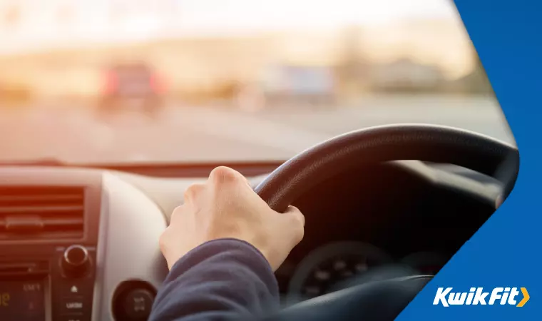 A driver holding the steering wheel.