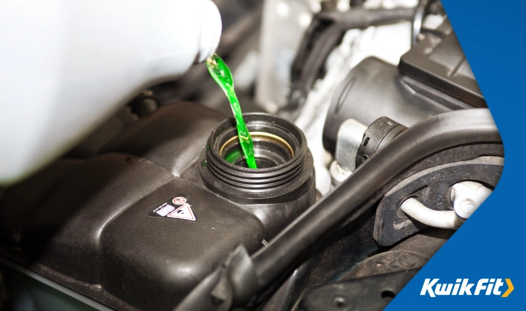 Person pouring antifreeze coolant into a car.