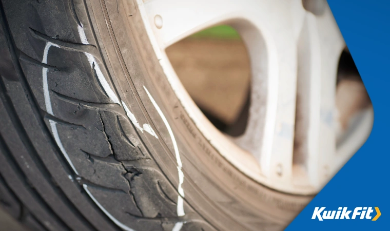 A severely damaged tyre after driving through a pothole.