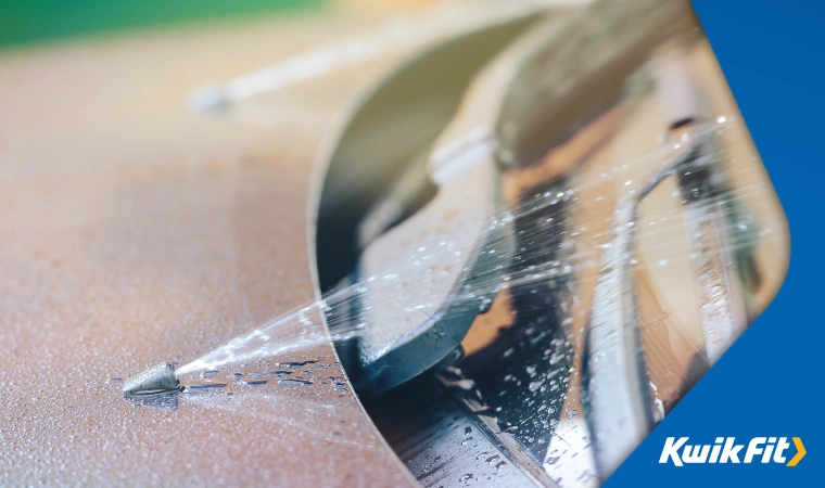 A car's washer fluid being sprayed onto the windscreen to keep it clean.