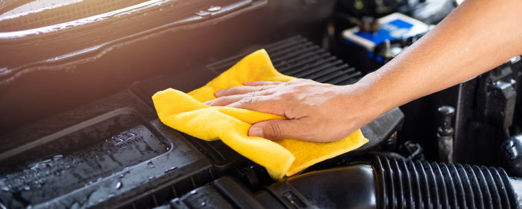 Person wiping car engine